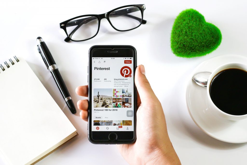 Person with first person view of Pinterest on cell phone