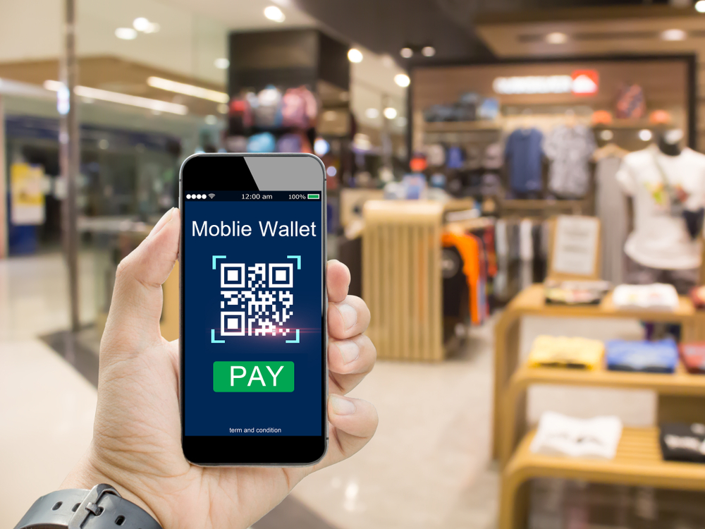 smartphone scanning QR code to pay