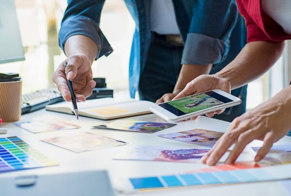 Creative content marketing team planning visual strategy with color palettes and brand materials