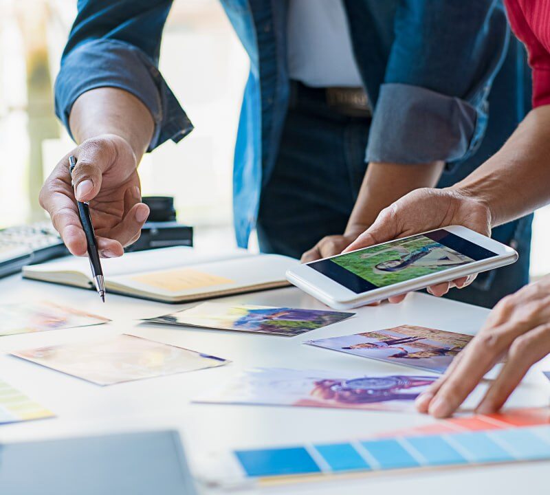 Creative content marketing team planning visual strategy with color palettes and brand materials